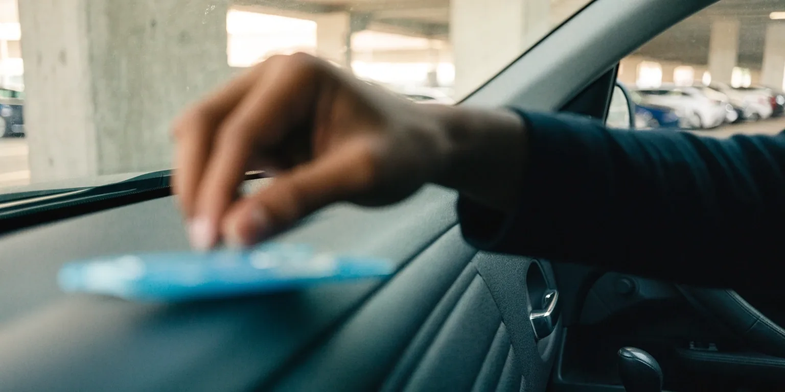 Driver preparing permit and booking details in parked car